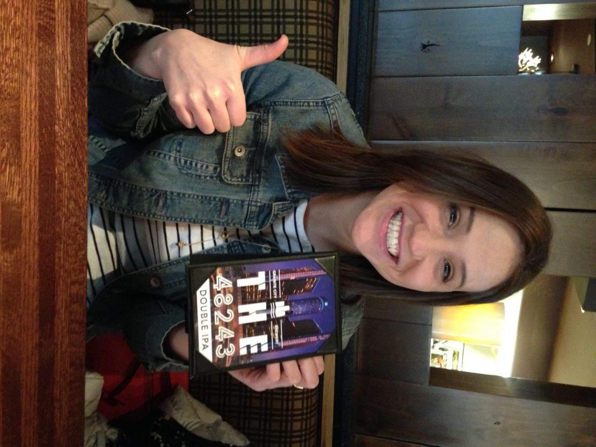 In-House Designer Ashley Dupuy posing with her 48234 graphic design